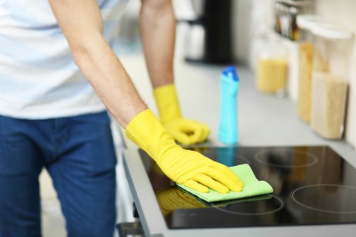 Professional cleaner in Queenspark following safe working practices